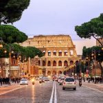 Rome, Italy - April 04: Traffic on the Via dei Fori Imperiali street in front of Colosseum in the evening, Rome, Italy, on April 04, 2013