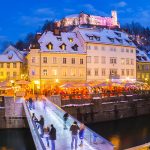 Ljubljana in Christmas time. Lively nightlife in old medieval city center decorated with Christmas lights. Slovenia, Europe. Shot at dusk with fish eye lens.